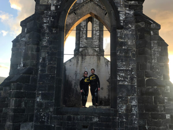 A couple posing in the window of a church