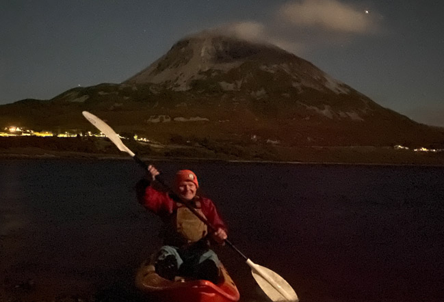 Dark sky kayaking with Joe McFadden in a kayak on Dunlewey lake with a mountain in the background