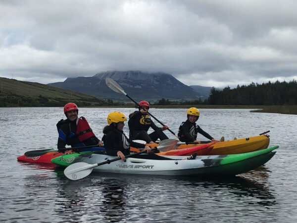 2 dads kayaking on Dunlewey Lake with 2 kids