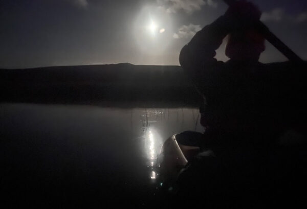 Moonlight paddle with moon in the sky behind