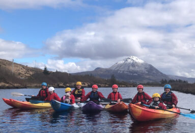 Family kayaking on Dunlewey Lake with group of all ages